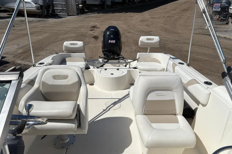 Slide: The Image of Interior view of a 2012 Pioneer 197 Venture boat with seating and motor. - 18