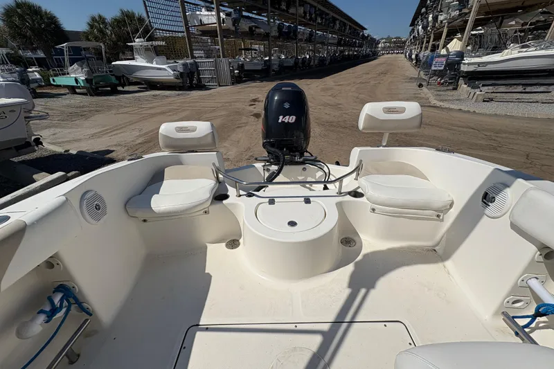Slide: The Image of Interior view of a 2012 Pioneer 197 Venture boat with seating and Suzuki 140 engine. - 23