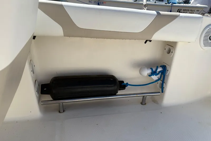 Slide: The Image of Interior view of a 2012 Pioneer 197 Venture boat with fender and rope storage. - 25