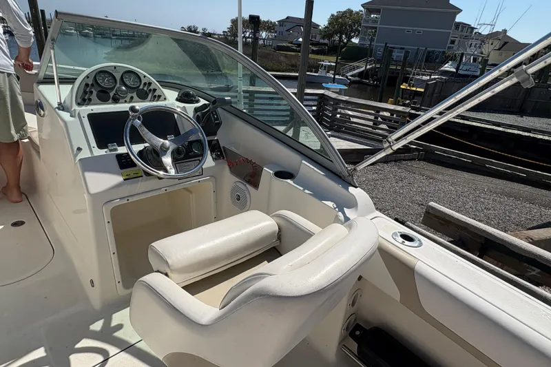 Slide: The Image of 2012 Pioneer 197 Venture boat cockpit with steering wheel and dashboard controls. - 29