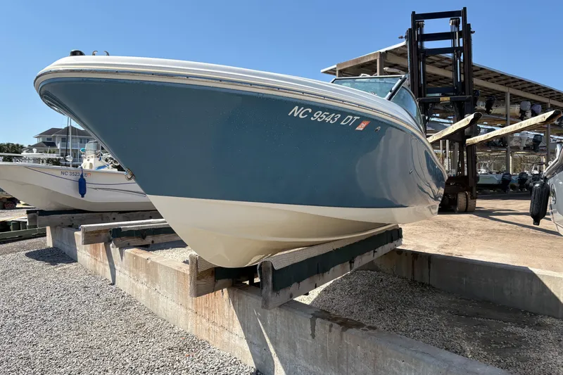 Slide: The Image of 2012 Pioneer 197 Venture boat on dry dock, blue hull, registration NC 9543 DT. - 3