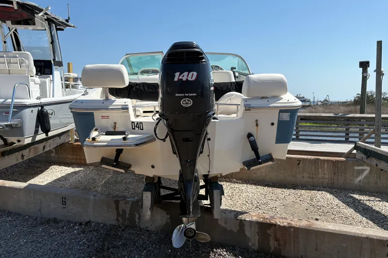 Slide: The Image of 2012 Pioneer 197 Venture boat with 140 HP outboard motor, docked outdoors. - 9