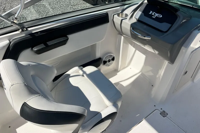 Slide: The Image of Interior of 2016 Chaparral 21 H2O Sport boat with white seating and dashboard. - 10
