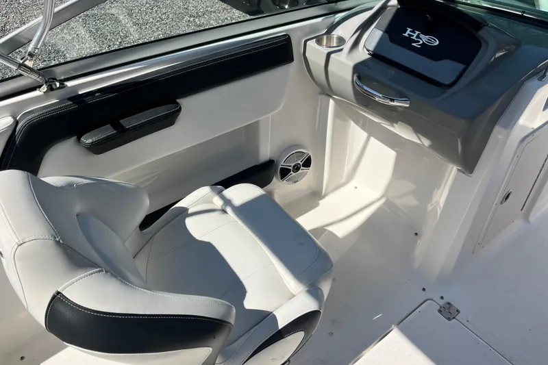 Slide: The Image of 2016 Chaparral 21 H2O Sport boat interior with white seating and dashboard. - 11