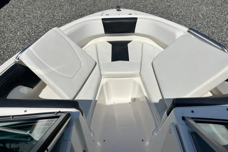 Slide: The Image of 2016 Chaparral 21 H2O Sport boat interior with white cushioned seating. - 14