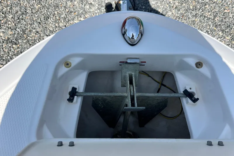 Slide: The Image of Anchor compartment of 2016 Chaparral 21 H2O Sport boat, featuring a secured anchor. - 15