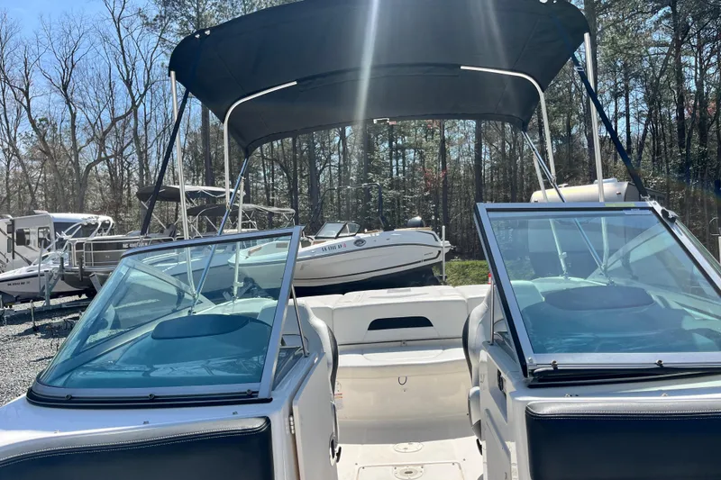 Slide: The Image of 2016 Chaparral 21 H2O Sport boat with canopy, parked outdoors. - 17