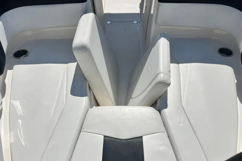 Slide: The Image of Interior seating of 2016 Chaparral 21 H2O Sport boat, featuring white upholstery. - 18