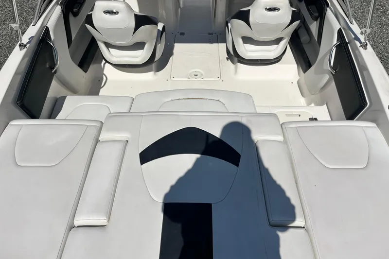 Slide: The Image of 2016 Chaparral 21 H2O Sport boat interior with white seating and modern design. - 6