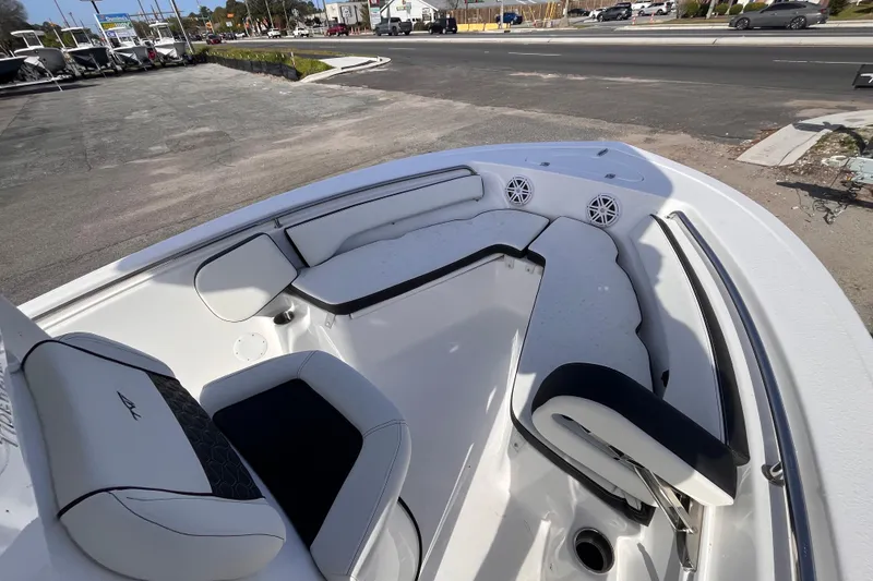 Slide: The Image of 2026 Tidewater 198 CC Adventure boat interior with cushioned seating and speakers. - 10