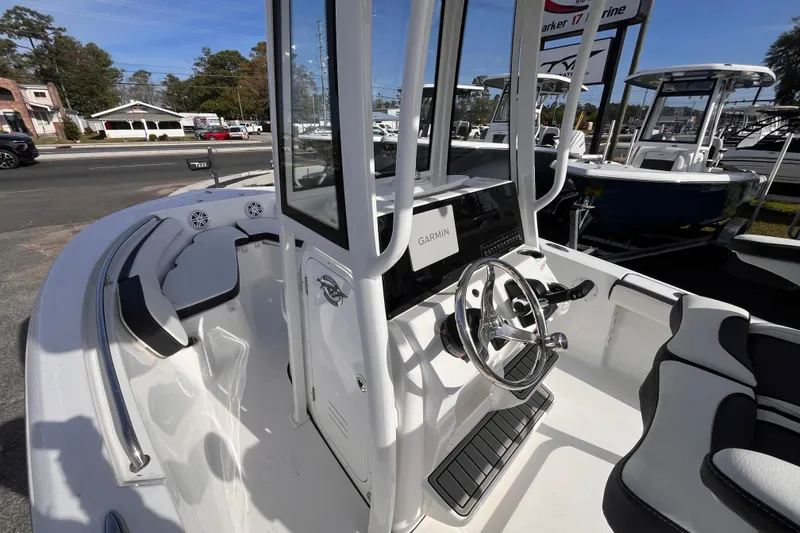 Slide: The Image of 2026 Tidewater 198 CC Adventure boat interior with steering wheel and seating. - 13