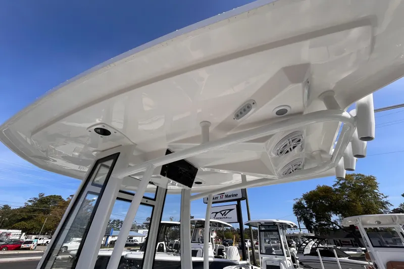 Slide: The Image of 2026 Tidewater 198 CC Adventure boat with T-top and speakers, displayed outdoors. - 14