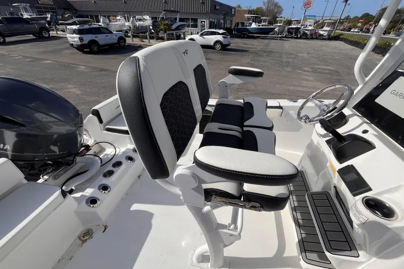 Slide: The Image of 2026 Tidewater 198 CC Adventure boat interior with seating and steering wheel. - 6