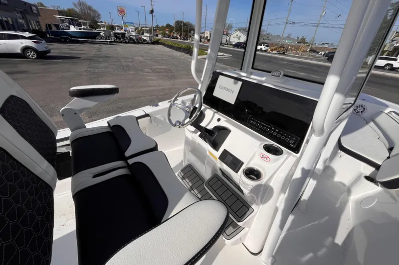 Slide: The Image of 2026 Tidewater 198 CC Adventure boat interior with Garmin navigation system and seating. - 7