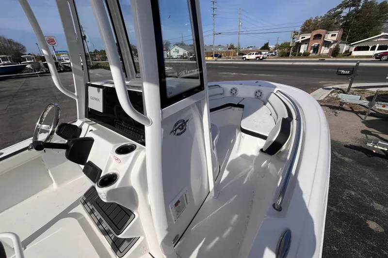 Slide: The Image of 2026 Tidewater 198 CC Adventure boat interior with steering console and seating. - 9