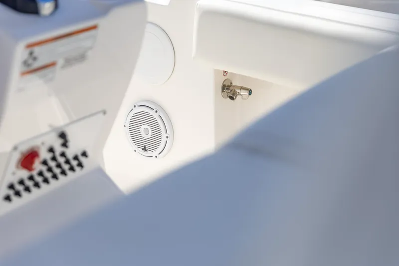 Slide: The Image of Interior view of 2022 Edgewater 245CC boat, featuring speaker and control panel. - 12
