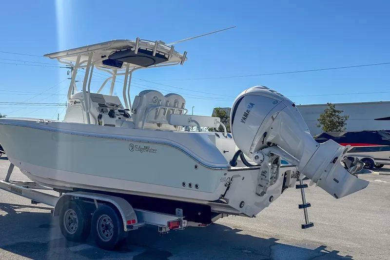 Slide: The Image of 2022 Edgewater 245CC boat on trailer with Yamaha outboard motor. - 19