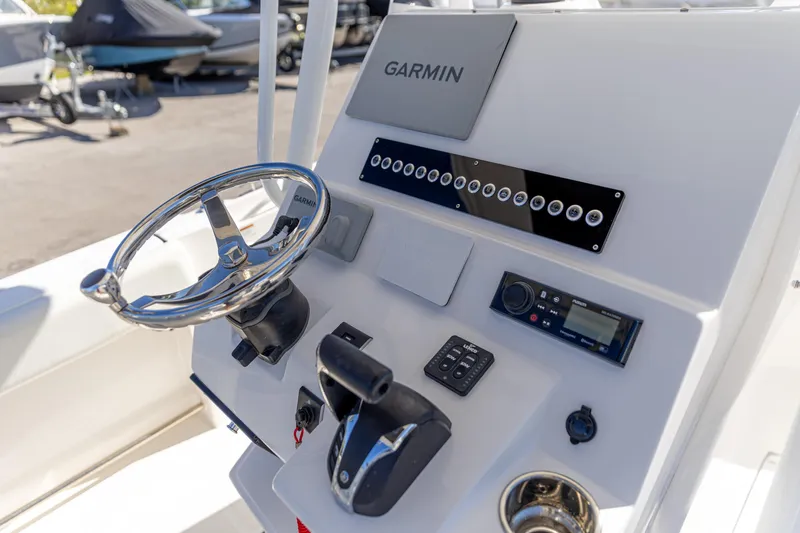 Slide: The Image of Edgewater 245CC 2022 boat dashboard with Garmin navigation system and controls. - 7