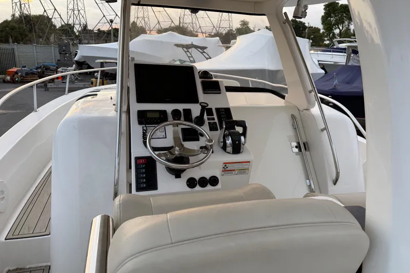 Slide: The Image of Cockpit of 2015 Belzona 32 Walkaround boat with steering wheel and control panel. - 10