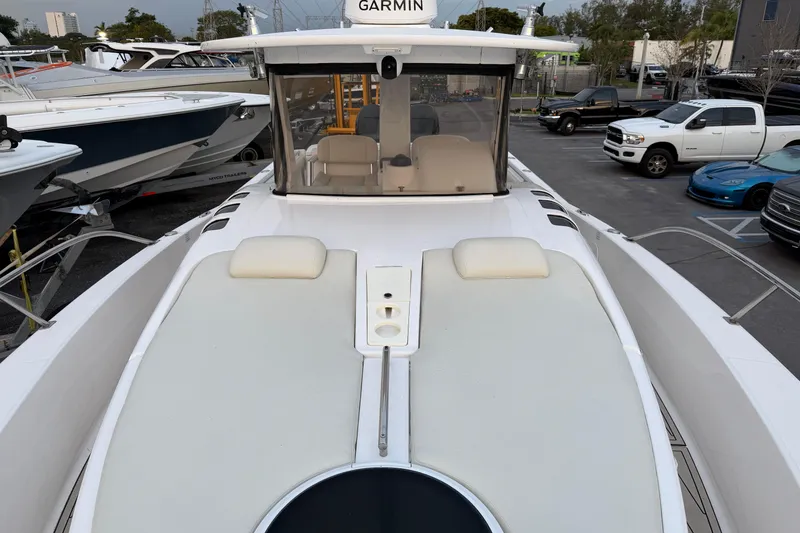 Slide: The Image of 2015 Belzona 32 Walkaround boat with Garmin equipment, docked in a marina. - 11