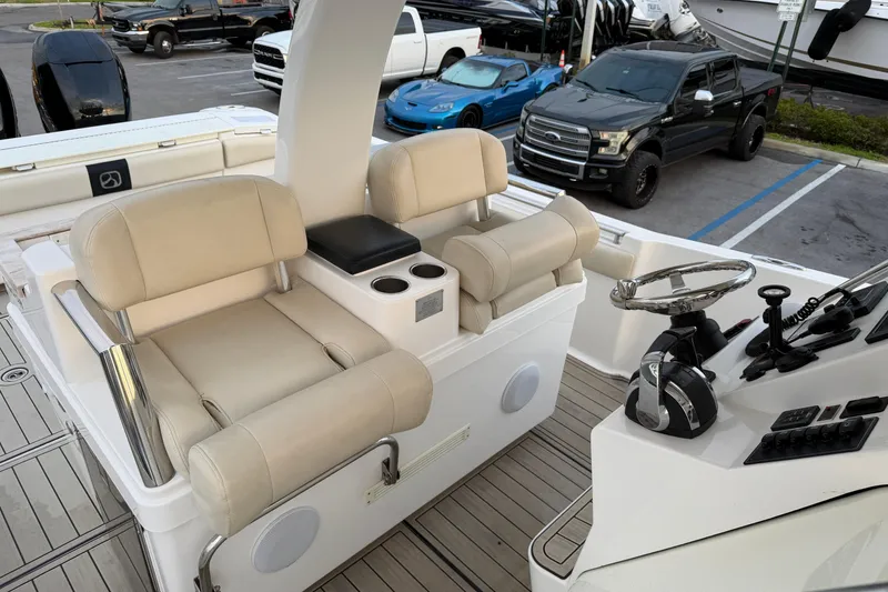 Slide: The Image of 2015 Belzona 32 Walkaround boat interior with dual helm seats and steering console. - 12