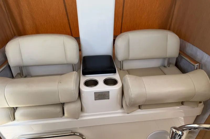 Slide: The Image of 2015 Belzona 32 Walkaround boat seating with cup holders and beige upholstery. - 19
