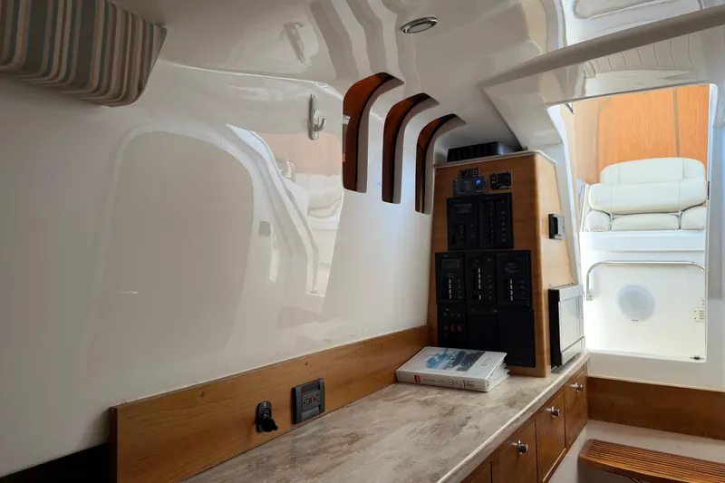Slide: The Image of Interior of 2015 Belzona 32 Walkaround boat with control panel and seating area. - 21