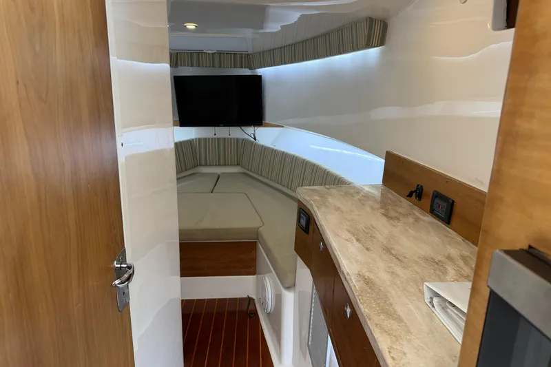 Slide: The Image of Interior of 2015 Belzona 32 Walkaround boat with cozy seating and TV. - 27
