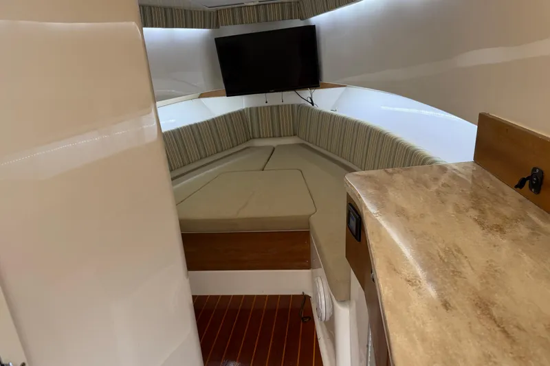 Slide: The Image of Interior of 2015 Belzona 32 Walkaround boat with cozy seating and mounted TV. - 28