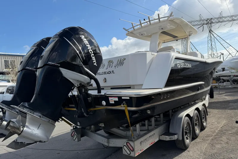 Slide: The Image of 2015 Belzona 32 Walkaround boat with twin Mercury Verado engines on a trailer. - 5