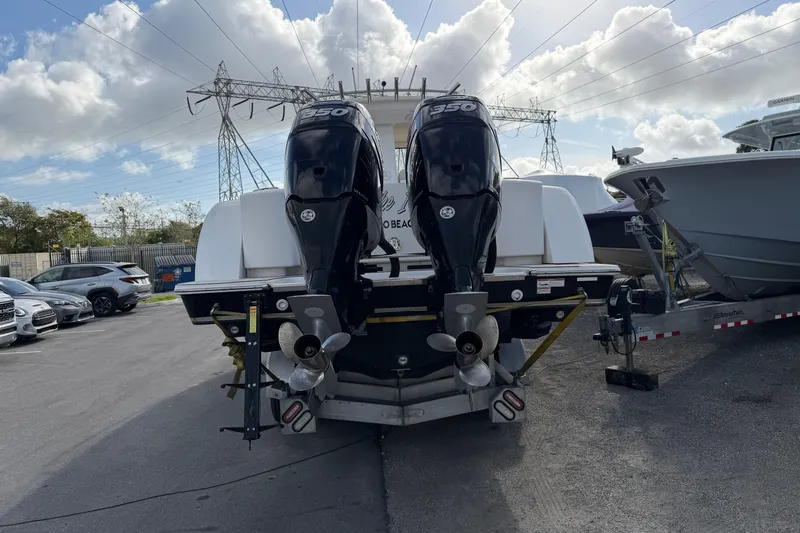 Slide: The Image of 2015 Belzona 32 Walkaround boat with dual 350 horsepower engines, parked outdoors. - 6