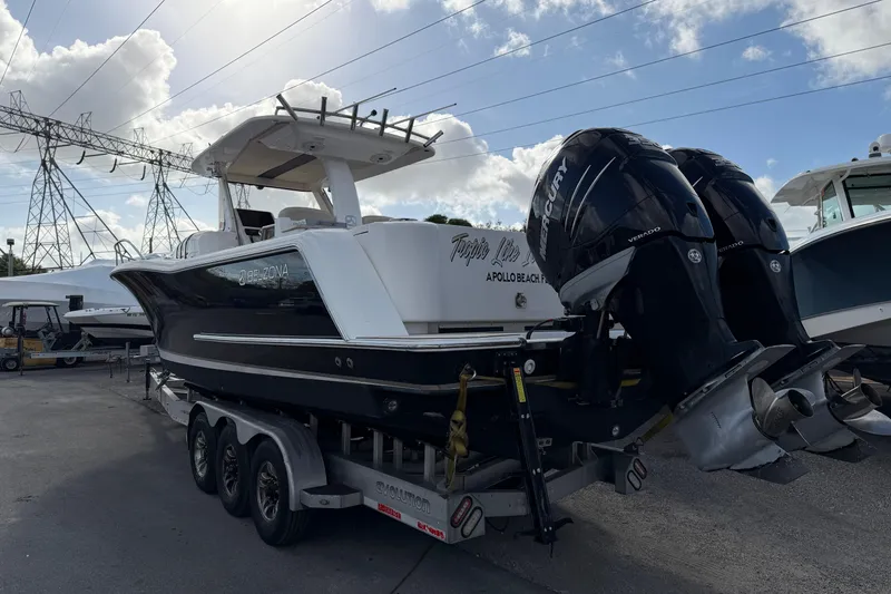 Slide: The Image of 2015 Belzona 32 Walkaround boat with dual Mercury engines on a trailer. - 7
