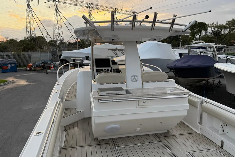 Slide: The Image of 2015 Belzona 32 Walkaround boat with spacious deck and modern amenities, docked at marina. - 8