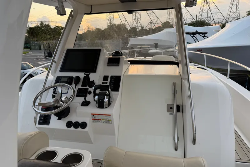 Slide: The Image of 2015 Belzona 32 Walkaround boat helm with steering wheel and control panel. - 9