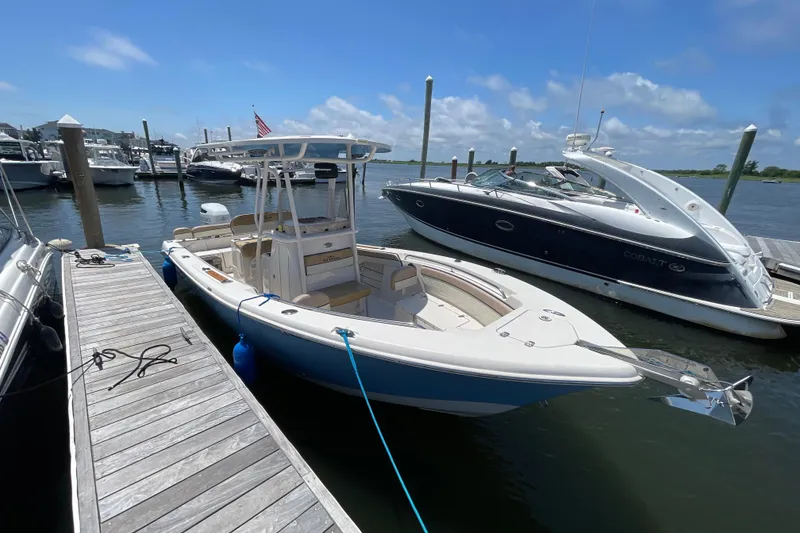 The Image of 2023 Sea Chaser 24 HFC boat docked at marina under clear blue sky. - 0