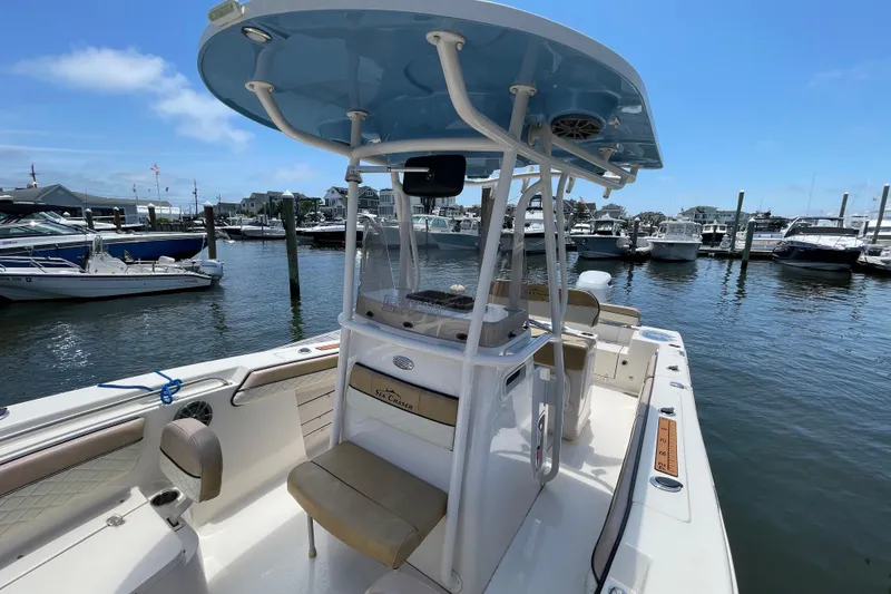 Slide: The Image of 2023 Sea Chaser 24 HFC boat docked at marina under clear blue sky. - 11