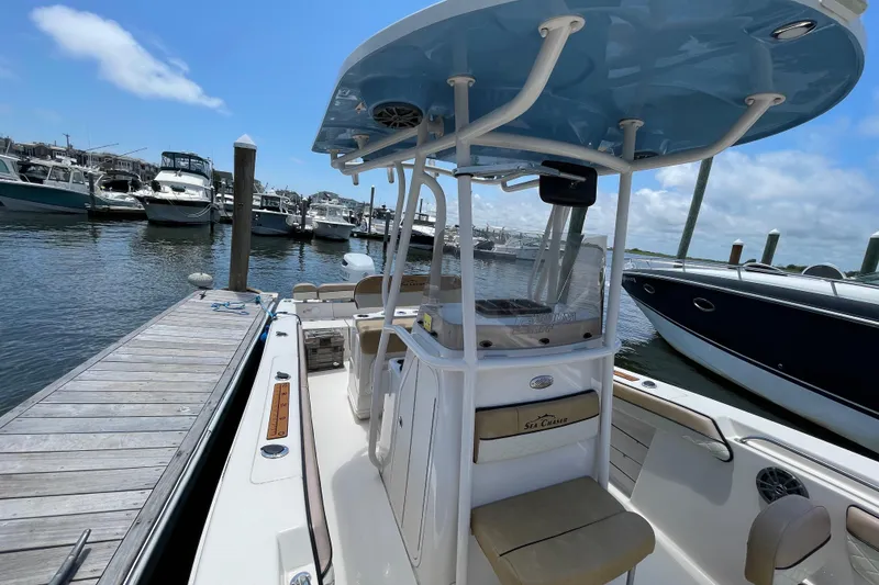 Slide: The Image of 2023 Sea Chaser 24 HFC boat docked at marina under clear blue sky. - 12