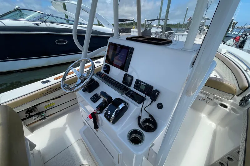 Slide: The Image of 2023 Sea Chaser 24 HFC boat console with steering wheel and navigation controls. - 15