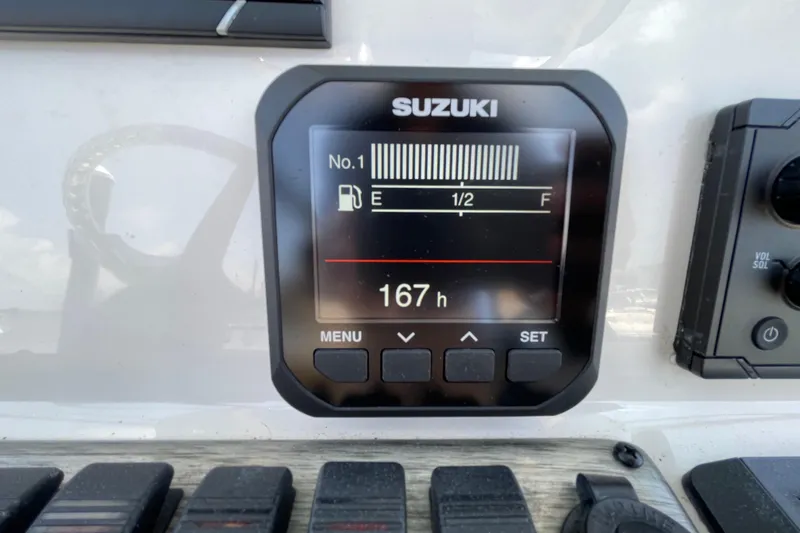 Slide: The Image of Suzuki fuel gauge display on 2023 Sea Chaser 24 HFC boat, showing 167 hours. - 18