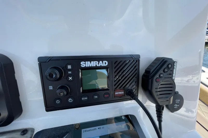 Slide: The Image of Simrad marine radio system on 2023 Sea Chaser 24 HFC boat dashboard. - 19