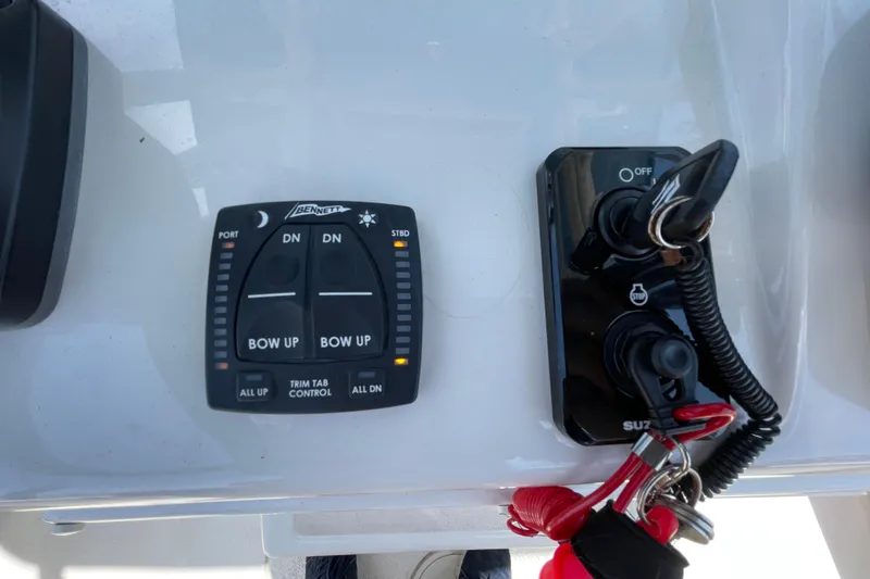 Slide: The Image of Control panel of a 2023 Sea Chaser 24 HFC boat with trim tab controls. - 22