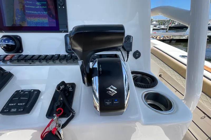 Slide: The Image of Control panel of 2023 Sea Chaser 24 HFC boat with Suzuki throttle and navigation equipment. - 23
