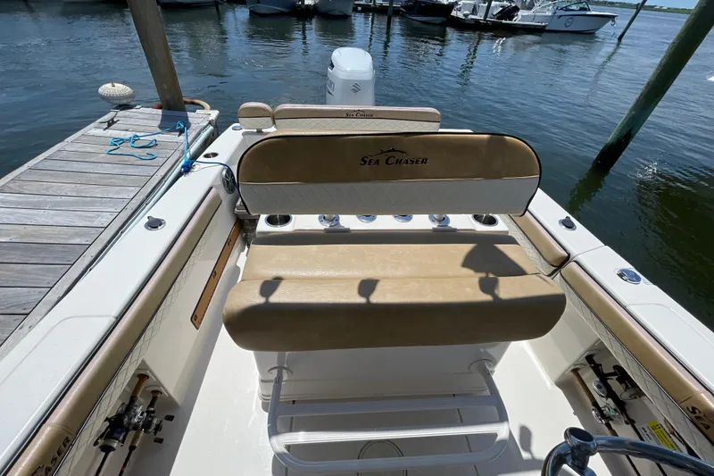 Slide: The Image of 2023 Sea Chaser 24 HFC boat interior with tan seating at dock. - 28