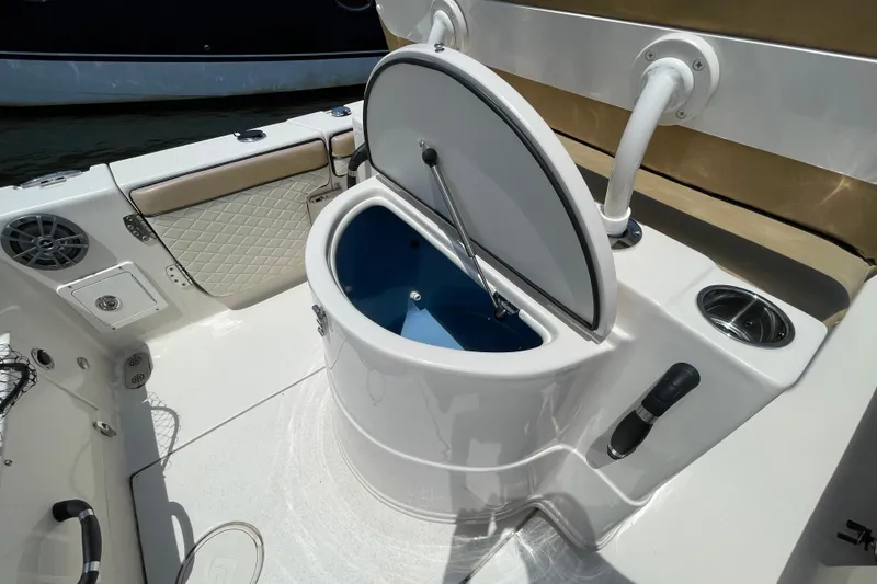 Slide: The Image of 2023 Sea Chaser 24 HFC boat interior with open storage compartment and seating. - 30