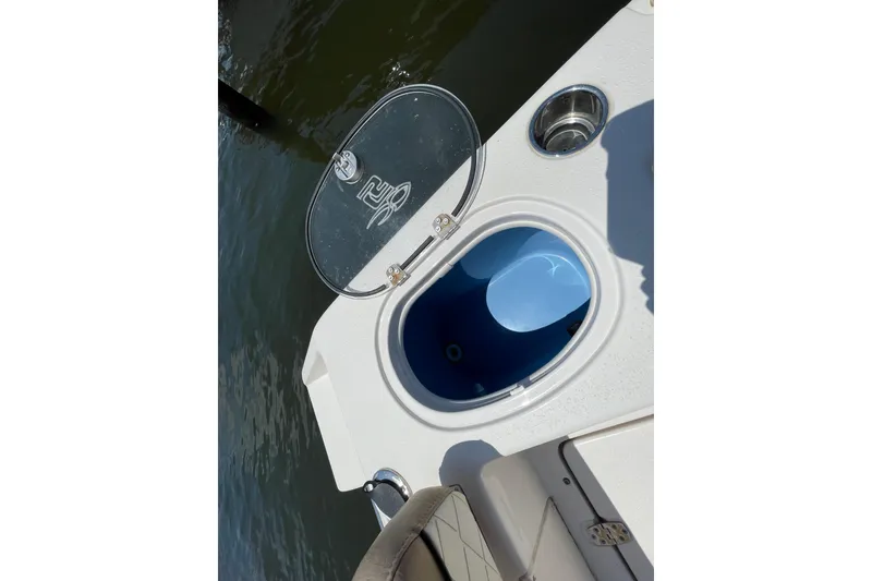 Slide: The Image of 2023 Sea Chaser 24 HFC boat with open storage compartment and cup holder. - 32