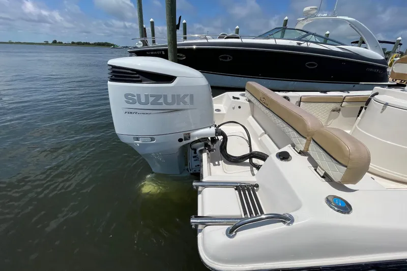 Slide: The Image of 2023 Sea Chaser 24 HFC boat with Suzuki outboard motor on calm water. - 35