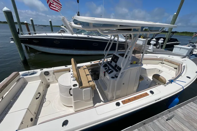 Slide: The Image of 2023 Sea Chaser 24 HFC boat docked, featuring spacious deck and modern console. - 36