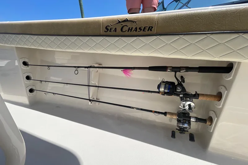 Slide: The Image of 2023 Sea Chaser 24 HFC boat with fishing rods stored in side compartment. - 40