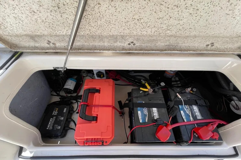 Slide: The Image of 2023 Sea Chaser 24 HFC boat battery compartment with dual batteries and charger. - 41