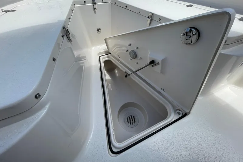 Slide: The Image of 2023 Sea Chaser 24 HFC boat storage compartment with open hatch and drainage system. - 7
